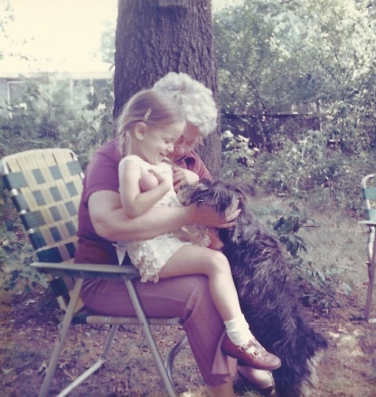 Grandma and I in her yard under the pines